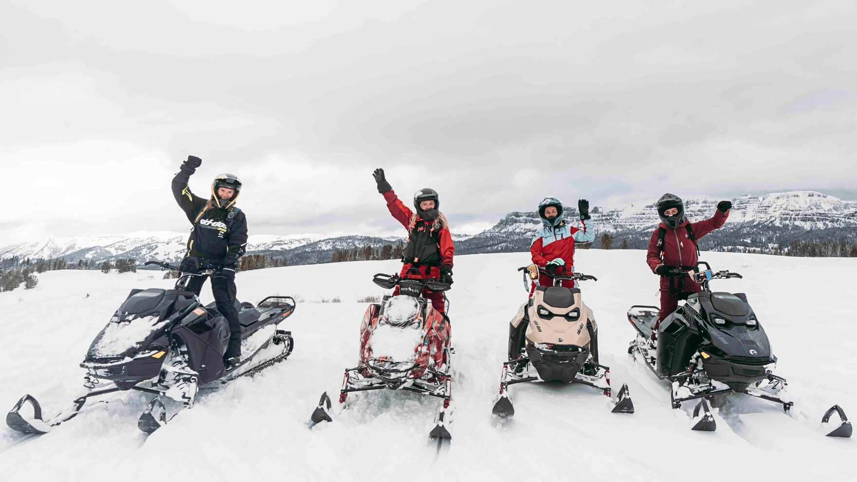 Four women enjoying the backcountry snowmobiling clinic