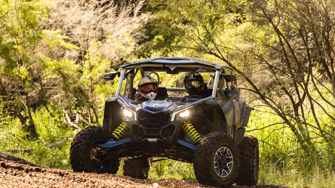 Two riders in a Can-Am Maverick